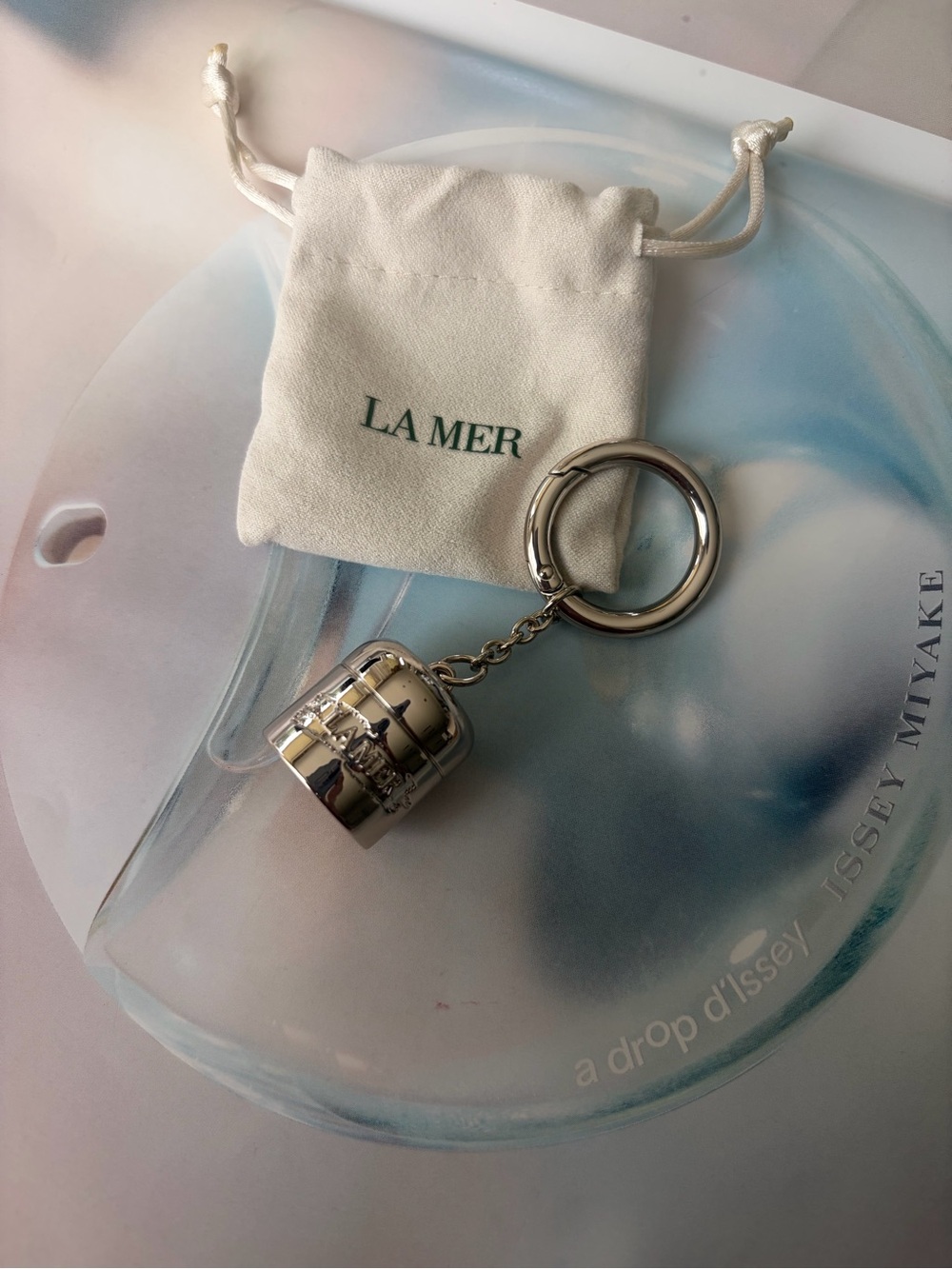 La Mer Silver Tone bag charm / Keychain with Drawstring Pouch